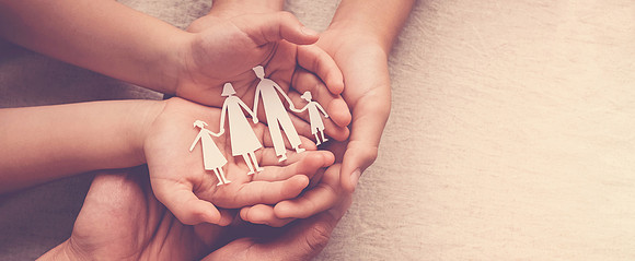 hands holding paper family cutout, family home, adoption foster care, homeless support , mental health, homeschooling , cost of living during  recession concept